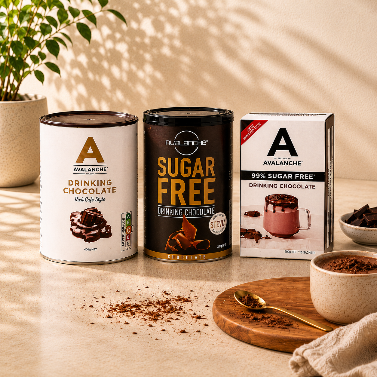 Avalanche drinking chocolate products on a wooden surface with a plant in the background